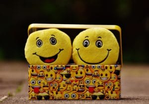 two happy-face emojis in a box of emojis