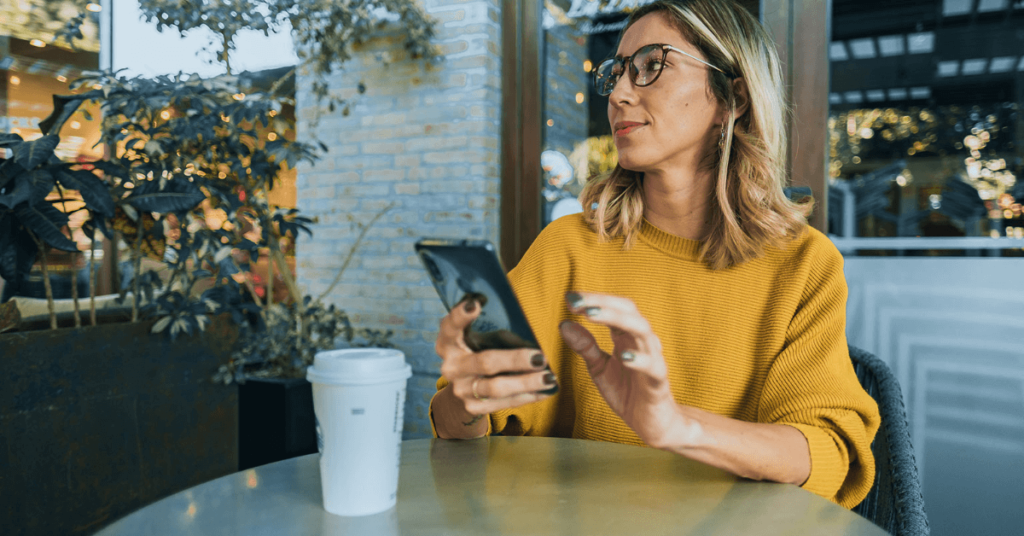 A woman in a yellow shirt uses receives a recommendation for a Starbucks drink via AI marketing tools.