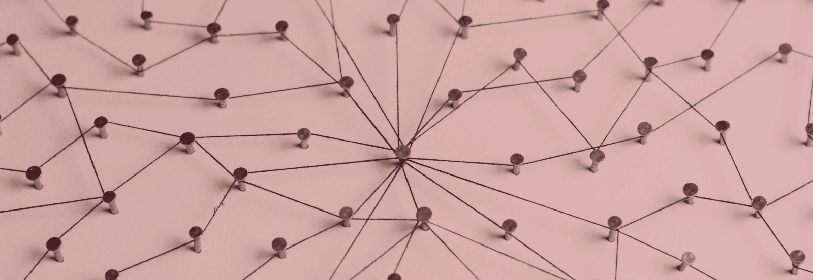 An interconnected web of string to symbolize the concept of interlinking on the internet. Image has a red tint.