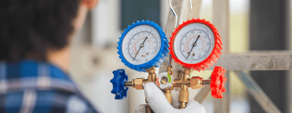 Close-up image of an HVAC technician performing a service call.