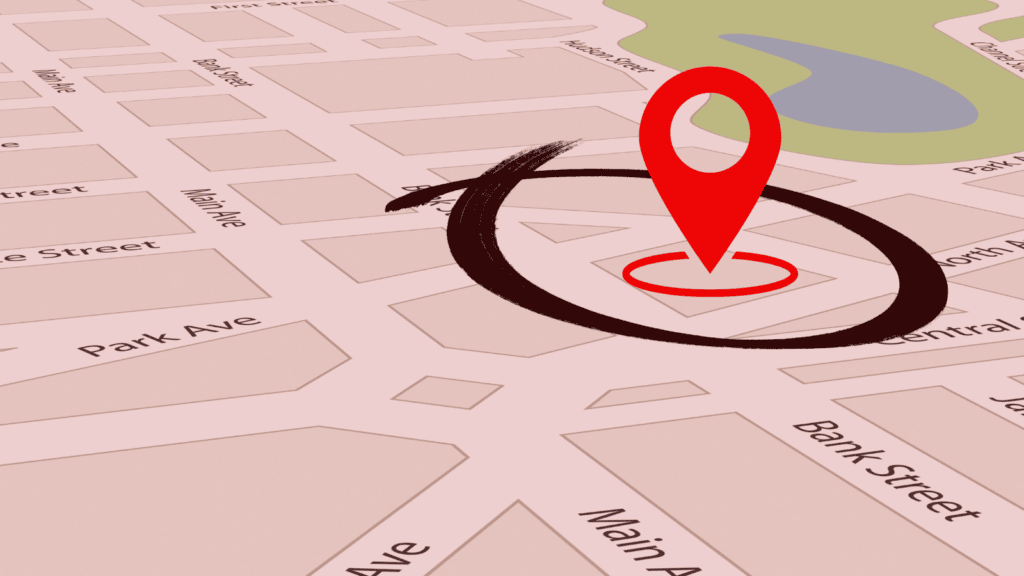 Google maps with a location pin on a street corner. A circle surrounds the pin, representing the concept of geofencing targeting. Red filter overtop.