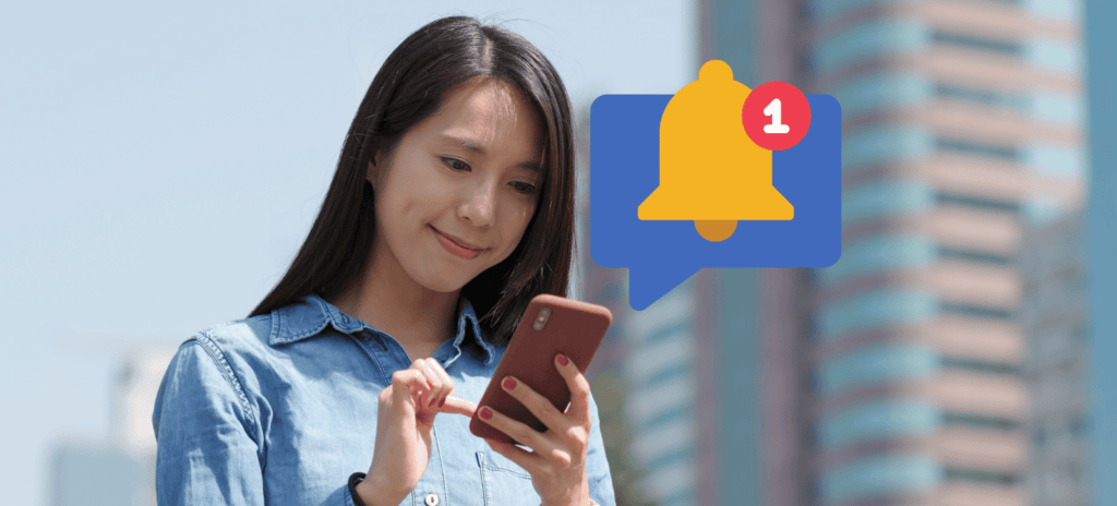 A woman browsing her phone receives a targeted ad/push notification.