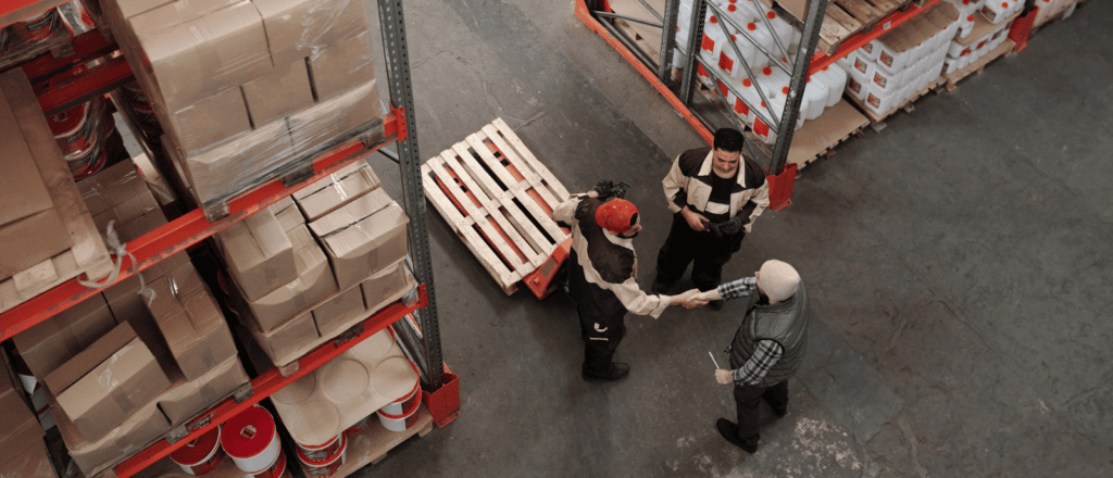 A bird's eye view of workers in a warehouse, representing the concept of industrial distribution.