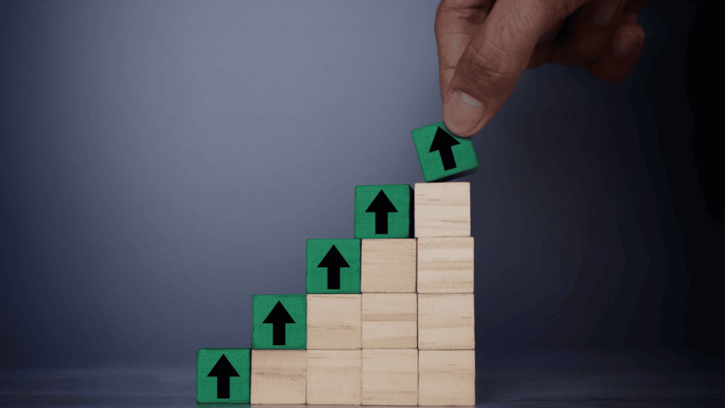 Wooden blocks stack higher, representing the concept of SEO being important for business and growing business by key metrics.