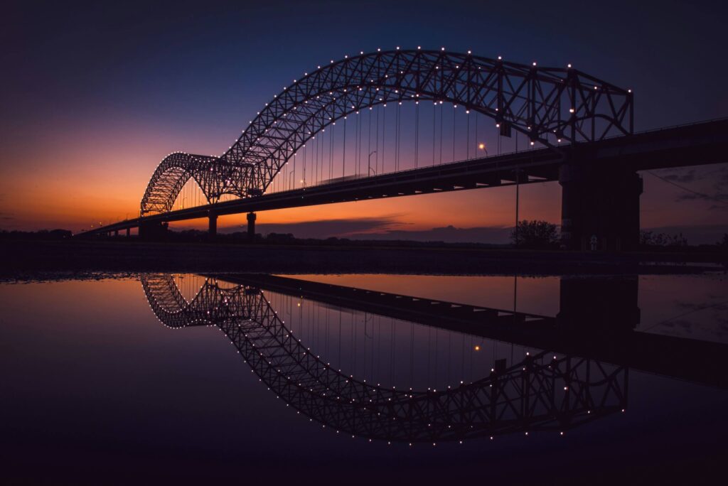 Reflection of Memphis/Arkansas bridge. Photo credit Joshua J. Cotten on Unsplash.