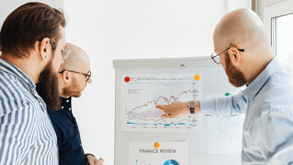 three men looking at SEO reporting numbers